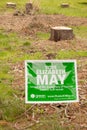 Green Party Sign and Tree Stumps