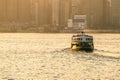 Green passenger Ferry in victoria harbour with cityscape background against morining sunrise, services between Kowloon and Hong Royalty Free Stock Photo