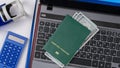 Green passport on the keyboard