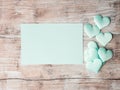 Green pastel hearts and paper invitation card