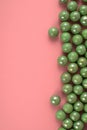 Green pastel marbles at soft pink background. Creative minimal concept