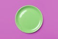 Green pastel plate on complementary pink background.