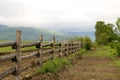 Green pasture and fence at mountains