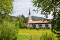 Green pasture with horses, view to St. Sixtus church Schliersee