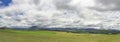 Green pastures, mountains and clouds Royalty Free Stock Photo