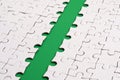The green path is laid on the platform of a white folded jigsaw puzzle. Texture image with copy space for text Royalty Free Stock Photo