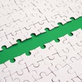 The green path is laid on the platform of a white folded jigsaw puzzle. Texture image with copy space for text Royalty Free Stock Photo