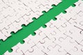The green path is laid on the platform of a white folded jigsaw puzzle. Texture image with copy space for text Royalty Free Stock Photo