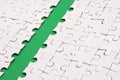 The green path is laid on the platform of a white folded jigsaw puzzle. Texture image with copy space for text Royalty Free Stock Photo