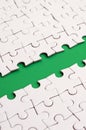 The green path is laid on the platform of a white folded jigsaw puzzle. Texture image with copy space for text Royalty Free Stock Photo