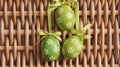 Green patterned Easter eggs arranged on wicker mat rustic spring decoration Royalty Free Stock Photo