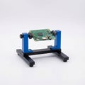 Green PCB Mounted on Blue and Black Workstation Jig Royalty Free Stock Photo