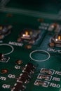 Green PCB with various electronic components soldered in place Royalty Free Stock Photo