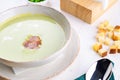 Green pea cream soup with bacon and cream in bowl with croutons. Royalty Free Stock Photo