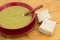 Green pea and ham soup, served with bread Royalty Free Stock Photo