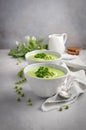 Green pea soup in bowls on grey concrete or stone background Royalty Free Stock Photo