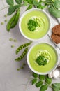 Green pea soup in bowls on grey concrete or stone background Royalty Free Stock Photo