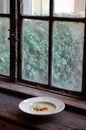 Green pea soup with bread and cheese on top Royalty Free Stock Photo