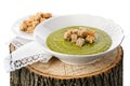 Green pea soup with croutons on the wooden stump Royalty Free Stock Photo