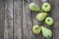 Green pears and apples with leafs on old, wooden table. High angle view Royalty Free Stock Photo