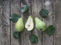 Green pears with leafs on old, wooden table. High angle view Royalty Free Stock Photo