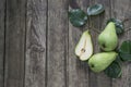 Green pears with leafs on old, wooden table. High angle view Royalty Free Stock Photo