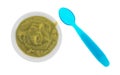 Green peas baby food mush in a bowl with spoon Royalty Free Stock Photo