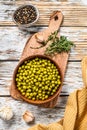 Green peas in a bowl. Canned food. White background. Top view Royalty Free Stock Photo