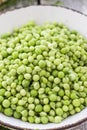 Green peas in a bowl top view