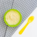 Green peas and broccoli baby puree in bowl isolated on white background, top view Royalty Free Stock Photo