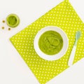 Green peas and broccoli baby puree in bowl isolated on white background, top view Royalty Free Stock Photo