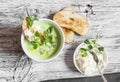 Green peas cream soup and cheese toast on the light wooden table Royalty Free Stock Photo