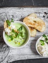 Green peas cream soup and cheese toast on the light wooden table Royalty Free Stock Photo