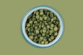 green peas in halves in bowl isolated on background. Top view. Flat lay Royalty Free Stock Photo