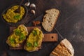Green peas hummus sandwiches on a dark background, top view, cop Royalty Free Stock Photo