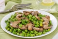 Green peas with mushrooms with glass of water