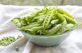 Green peas. Slide the pods in a glass bowl. Fresh vegetables, legumes Royalty Free Stock Photo
