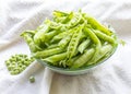 Green peas. Slide the pods in a glass bowl. Fresh vegetables, legumes Royalty Free Stock Photo