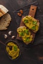 Green peas spread on sandwiches on a wooden board, top view. Healthy vegetarian food concept. Royalty Free Stock Photo