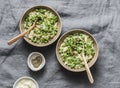 Green peas, spring herbs orzotto on a gray background, top view. Vegetarian food concept Royalty Free Stock Photo