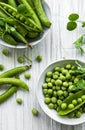 Green peas in white bowl with fresh pods Royalty Free Stock Photo