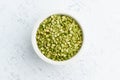 Green peas in white bowl on white background. Dried cereals in cup, vegan food. Top view, close up Royalty Free Stock Photo