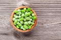 Green peas in wooden bowl Royalty Free Stock Photo