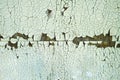 Green peeling paint on the wooden wall. Weathered rough painted surface with patterns of cracks and flaking. Texture Royalty Free Stock Photo