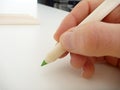 Green pencil in a hand writing Royalty Free Stock Photo
