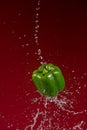 Green Pepper on Red Background