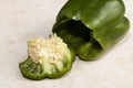 Green Pepper With Top Cut Off On Tile Cutting Board