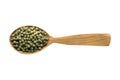 Green peppercorn seeds in wooden spoon isolated on white background. spice for cooking food, top view