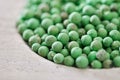 Green peppercorn in wooden bowl