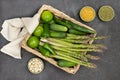 Green peppers, asparagus, cucumbers and limes in rattan basket